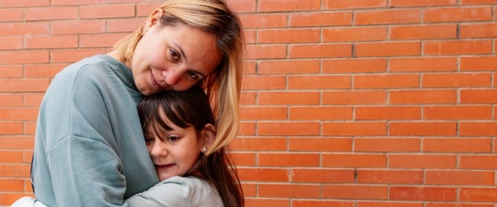 woman hugging a girl